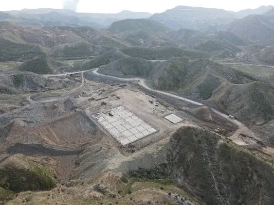 Aerial view of a well pad in mountainous terrain